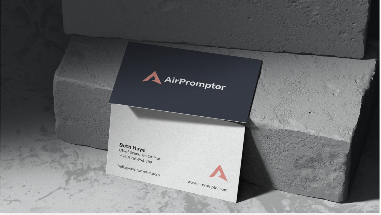 Business card application showing AirPrompter branded business cards on a textured surface.